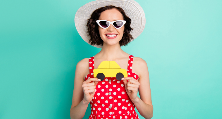 Woman holding a cut out car