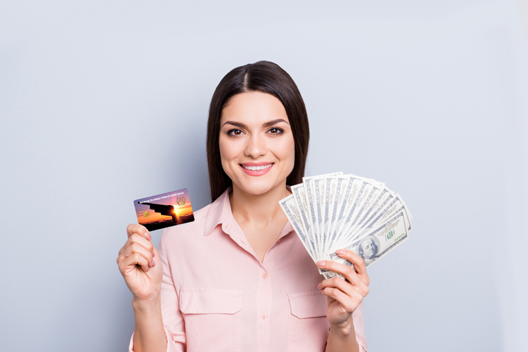 Woman holding credit card and cash